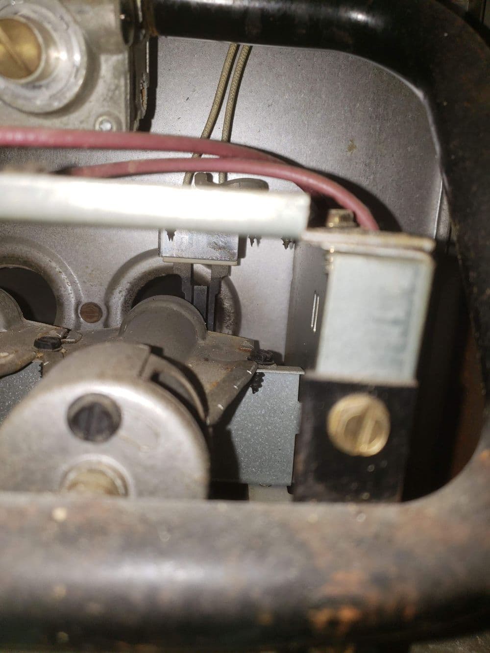 Close-up of mechanical components and wiring inside a vintage machine or device.