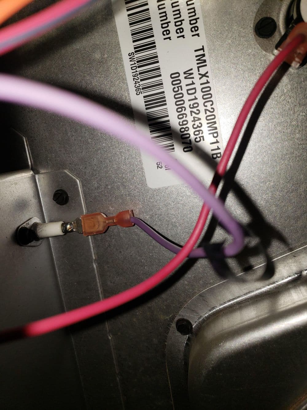 Close-up of electrical connections in a TMX100C220MP1B unit showing wires and terminal connections.